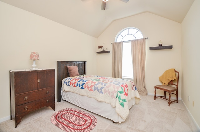 bedroom featuring ceiling fan, light colored carpet, and vaulted ceiling