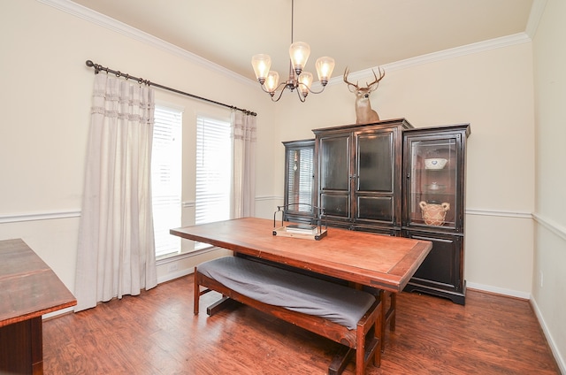 dining room with ornamental molding, a chandelier, and dark wood-type flooring