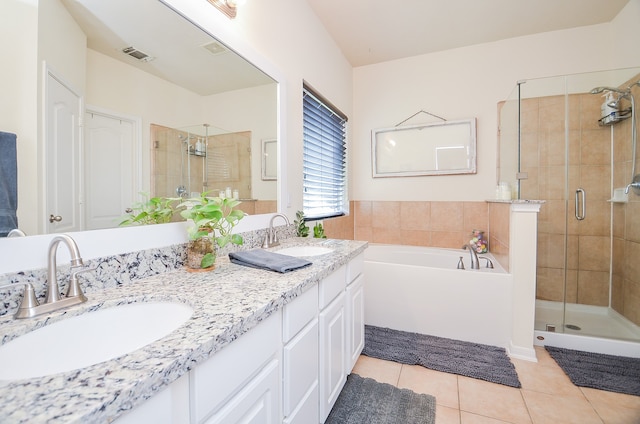 bathroom featuring tile patterned floors, independent shower and bath, and vanity