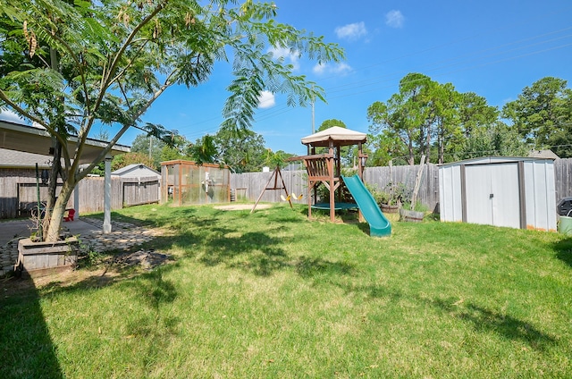 exterior space featuring a playground and a shed