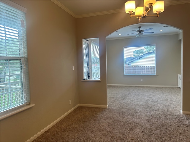 carpeted empty room featuring ceiling fan with notable chandelier and ornamental molding