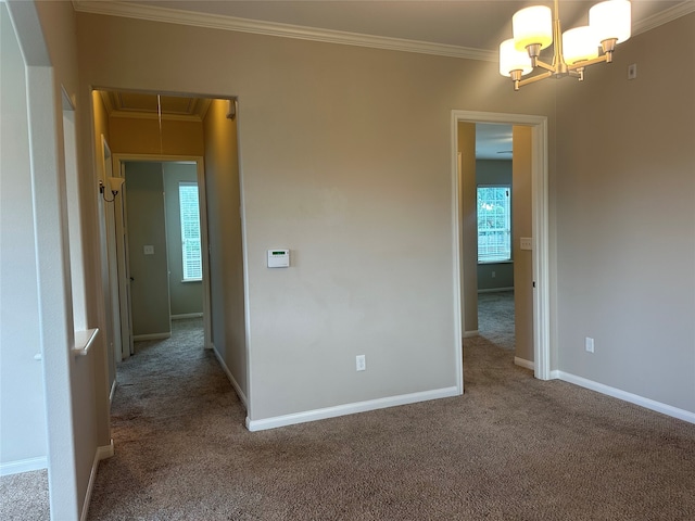 unfurnished room with a notable chandelier, crown molding, and carpet flooring