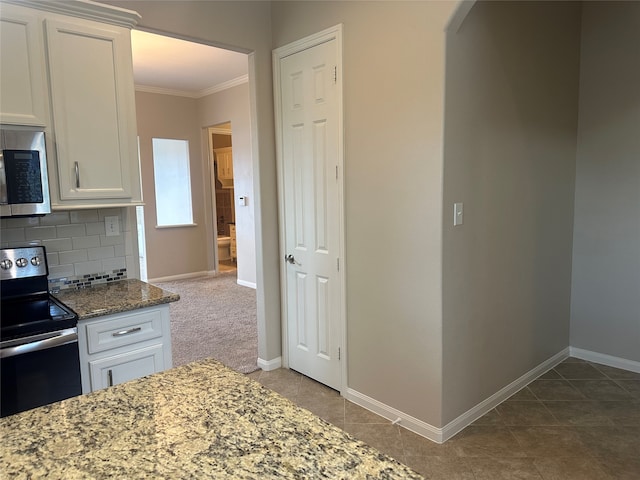 kitchen featuring decorative backsplash, white cabinetry, stainless steel appliances, crown molding, and stone counters