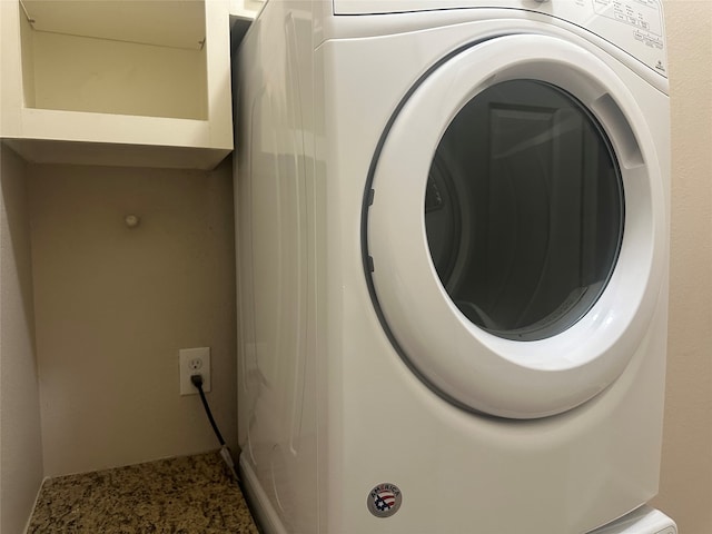 clothes washing area with washer / clothes dryer