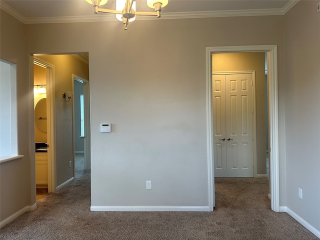 unfurnished bedroom with carpet, crown molding, and a closet