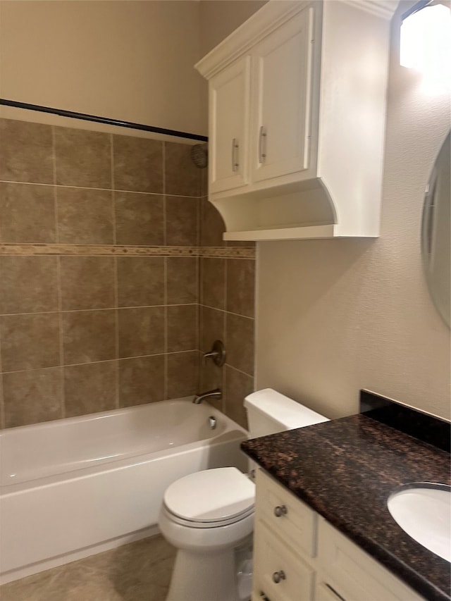 full bathroom with tiled shower / bath, vanity, and toilet