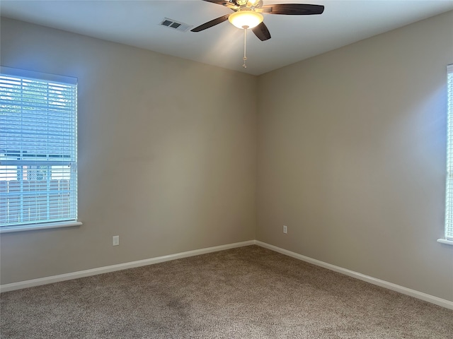 empty room featuring carpet and ceiling fan