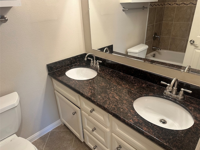 full bathroom with tiled shower / bath combo, vanity, toilet, and tile patterned floors