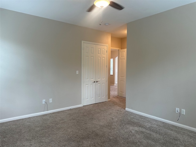 carpeted spare room with ceiling fan