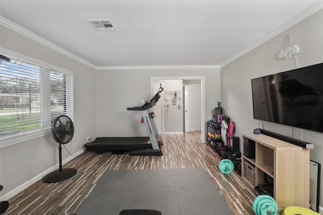 workout room featuring ornamental molding