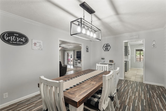 dining room with ceiling fan, dark wood-type flooring, and ornamental molding