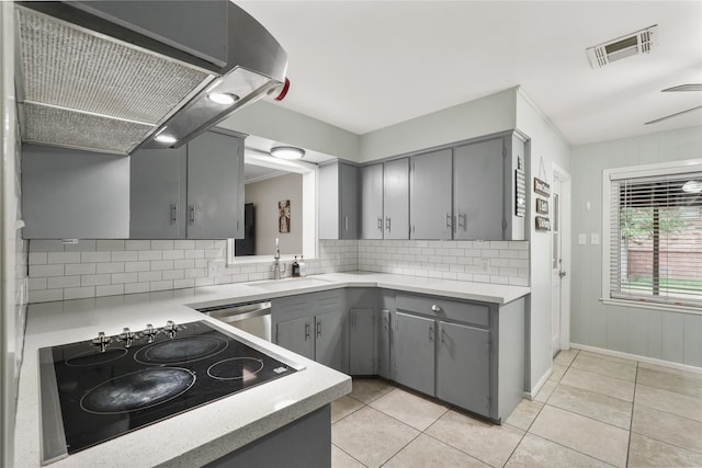 kitchen featuring black electric cooktop, gray cabinetry, and exhaust hood