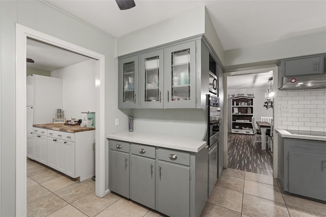 kitchen featuring black appliances, ceiling fan, gray cabinets, tasteful backsplash, and light tile patterned flooring