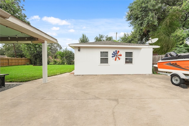 exterior space featuring an outdoor structure and a lawn