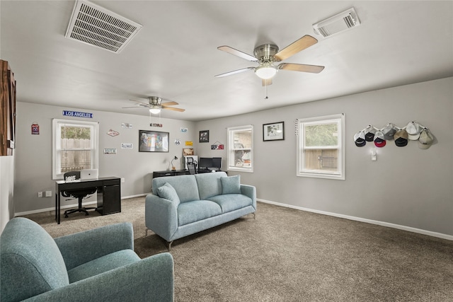 carpeted living room featuring ceiling fan and plenty of natural light