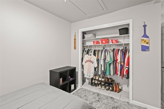 bedroom with a closet and light tile patterned flooring