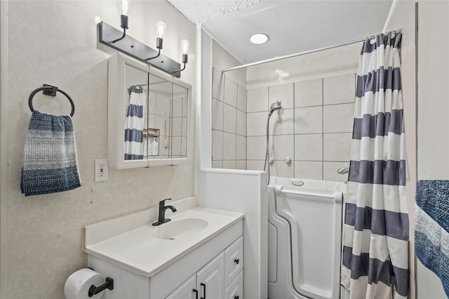 bathroom featuring vanity, curtained shower, and crown molding