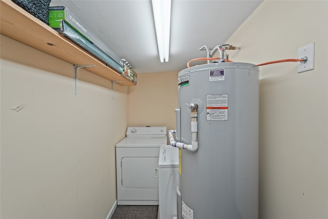 laundry area with washer and dryer and water heater