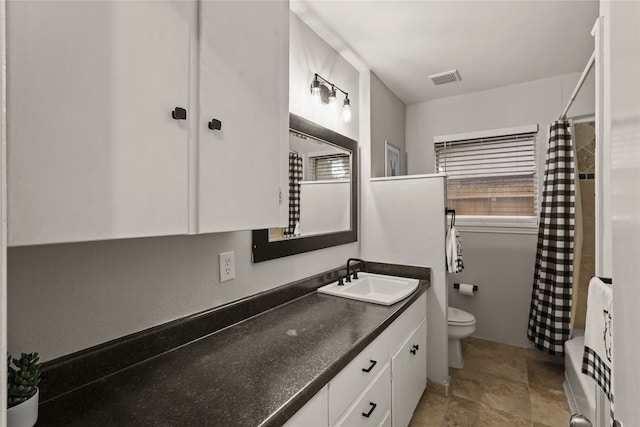 full bathroom featuring vanity, toilet, and shower / bath combo with shower curtain