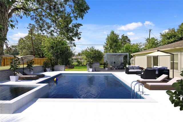 view of pool featuring a patio area, an outdoor living space, and a storage unit