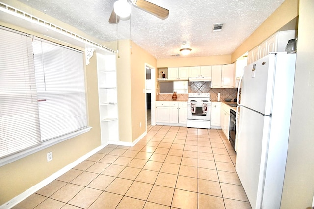 kitchen featuring white cabinets, backsplash, white appliances, light tile patterned floors, and ceiling fan