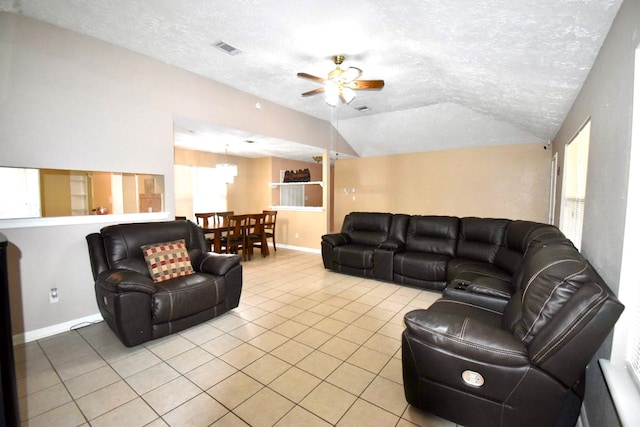 tiled living room featuring ceiling fan, a textured ceiling, and vaulted ceiling