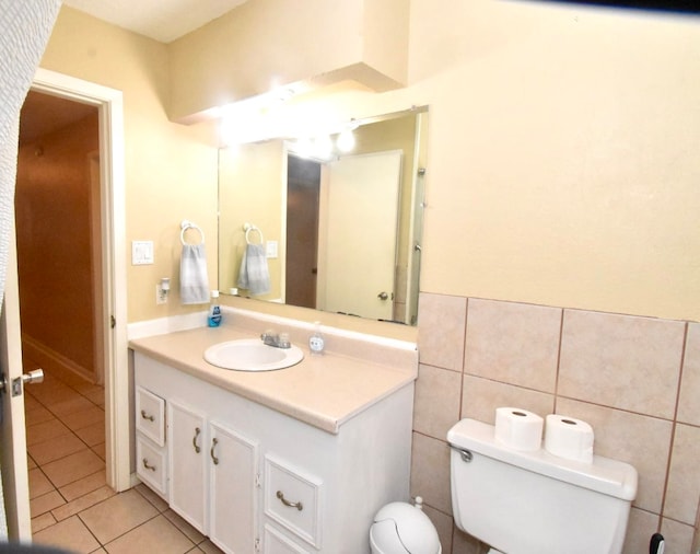 bathroom featuring vanity, tile walls, toilet, and tile patterned floors