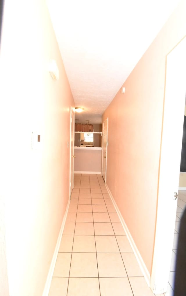 hallway with light tile patterned flooring