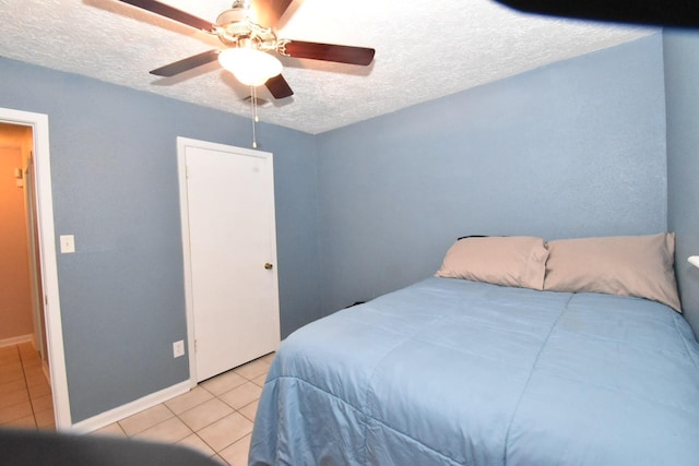 1315 Leadenhall Cir, Channelview, TX 77530 - bedroom with light tile patterned flooring, a textured ceiling, ceiling fan, and baseboards