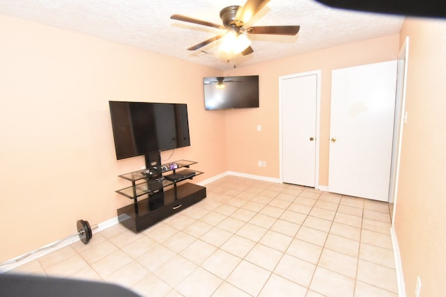 tiled living room featuring ceiling fan and a textured ceiling