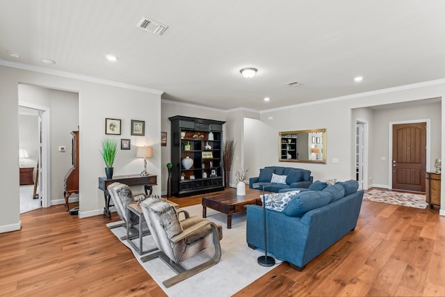 living room featuring light hardwood / wood-style flooring and crown molding