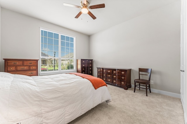 bedroom with ceiling fan and light carpet