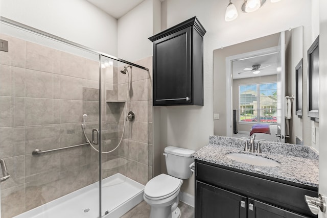 bathroom featuring ceiling fan, walk in shower, vanity, and toilet