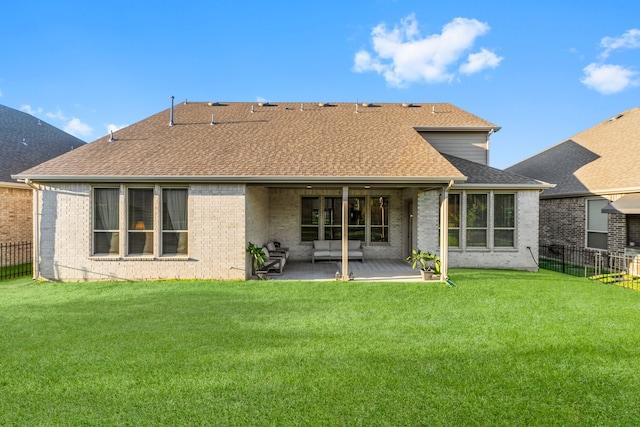 rear view of property featuring a yard and a patio area