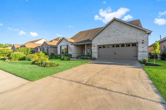 view of front of home with a garage and a front lawn