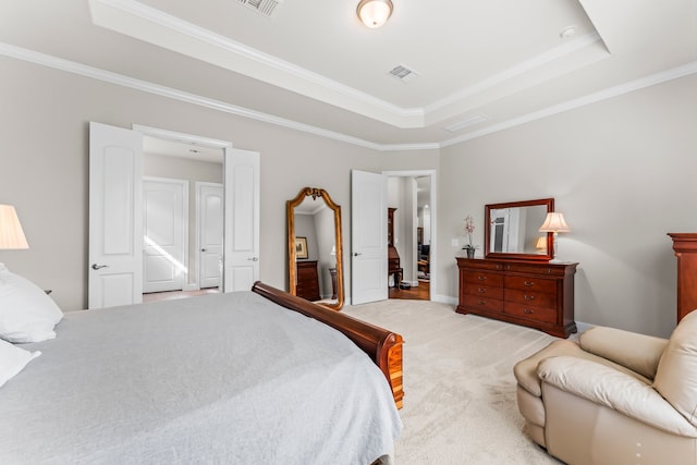 bedroom with ornamental molding, light colored carpet, and a raised ceiling