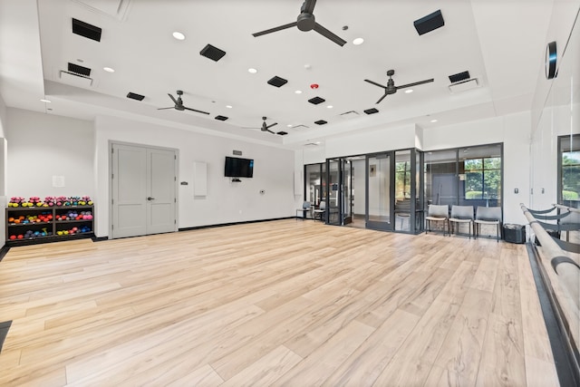 workout area featuring light hardwood / wood-style flooring and ceiling fan