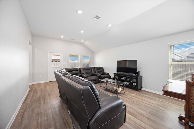 living room with light wood-type flooring and lofted ceiling