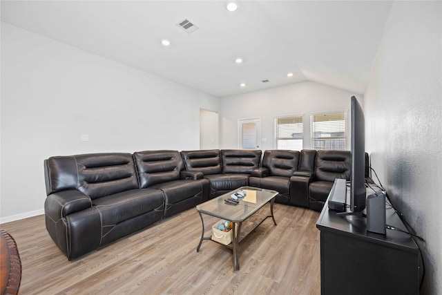 living room with light hardwood / wood-style flooring and vaulted ceiling