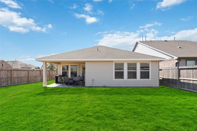 back of house with a patio area and a lawn