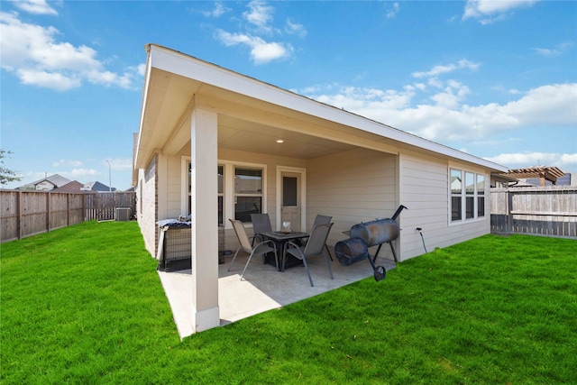 back of house featuring a yard and a patio