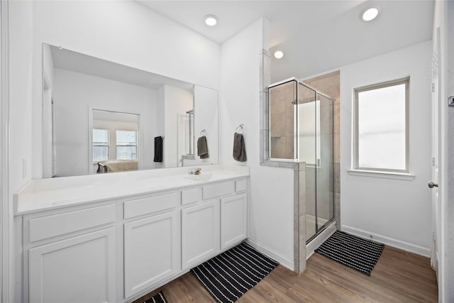 bathroom with an enclosed shower, vanity, and hardwood / wood-style flooring