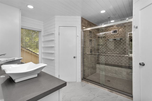 bathroom featuring wooden walls, walk in shower, and vanity