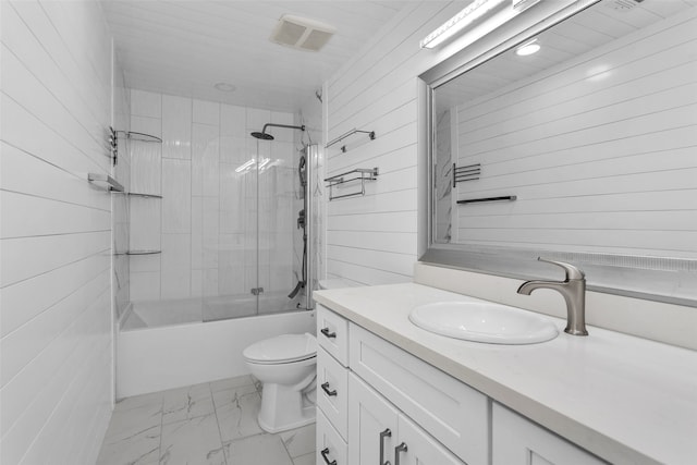 full bathroom featuring tiled shower / bath combo, vanity, toilet, and wood walls