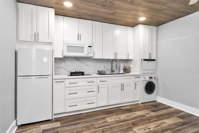 331 Cypresswood Dr, Spring, TX 77388 - kitchen with white appliances, a sink, wooden ceiling, light countertops, and estacked washer and dryer