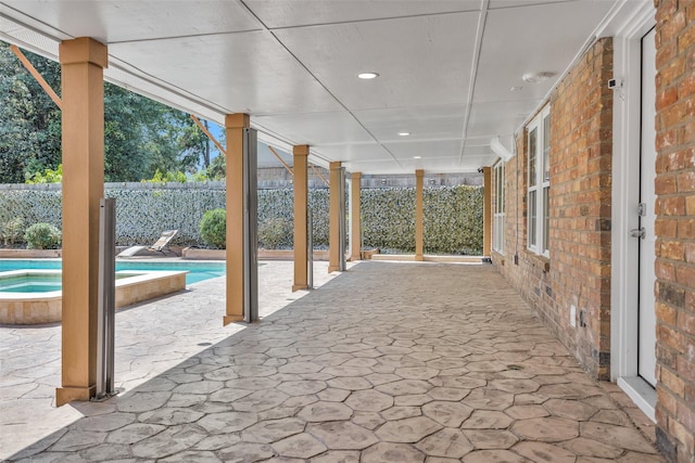 331 Cypresswood Dr, Spring, TX 77388 - view of patio / terrace featuring fence and an in-ground hot tub
