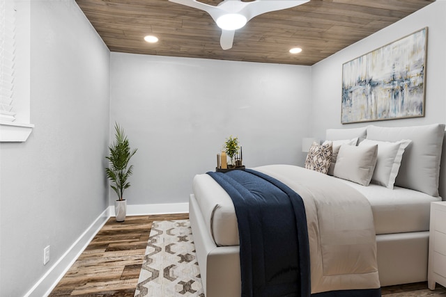 bedroom featuring wood ceiling, ceiling fan, and dark hardwood / wood-style flooring