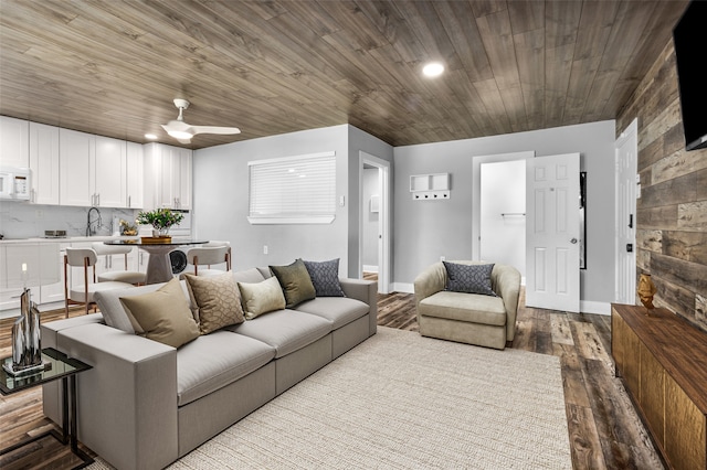 living room with ceiling fan, sink, and light hardwood / wood-style floors