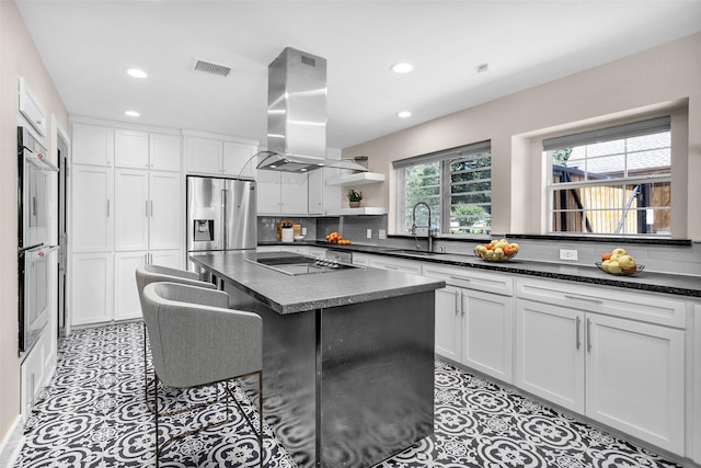 331 Cypresswood Dr, Spring, TX 77388 - kitchen featuring a sink, island exhaust hood, stainless steel appliances, dark countertops, and recessed lighting
