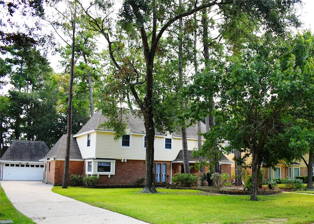 view of front of house with a garage and a front lawn